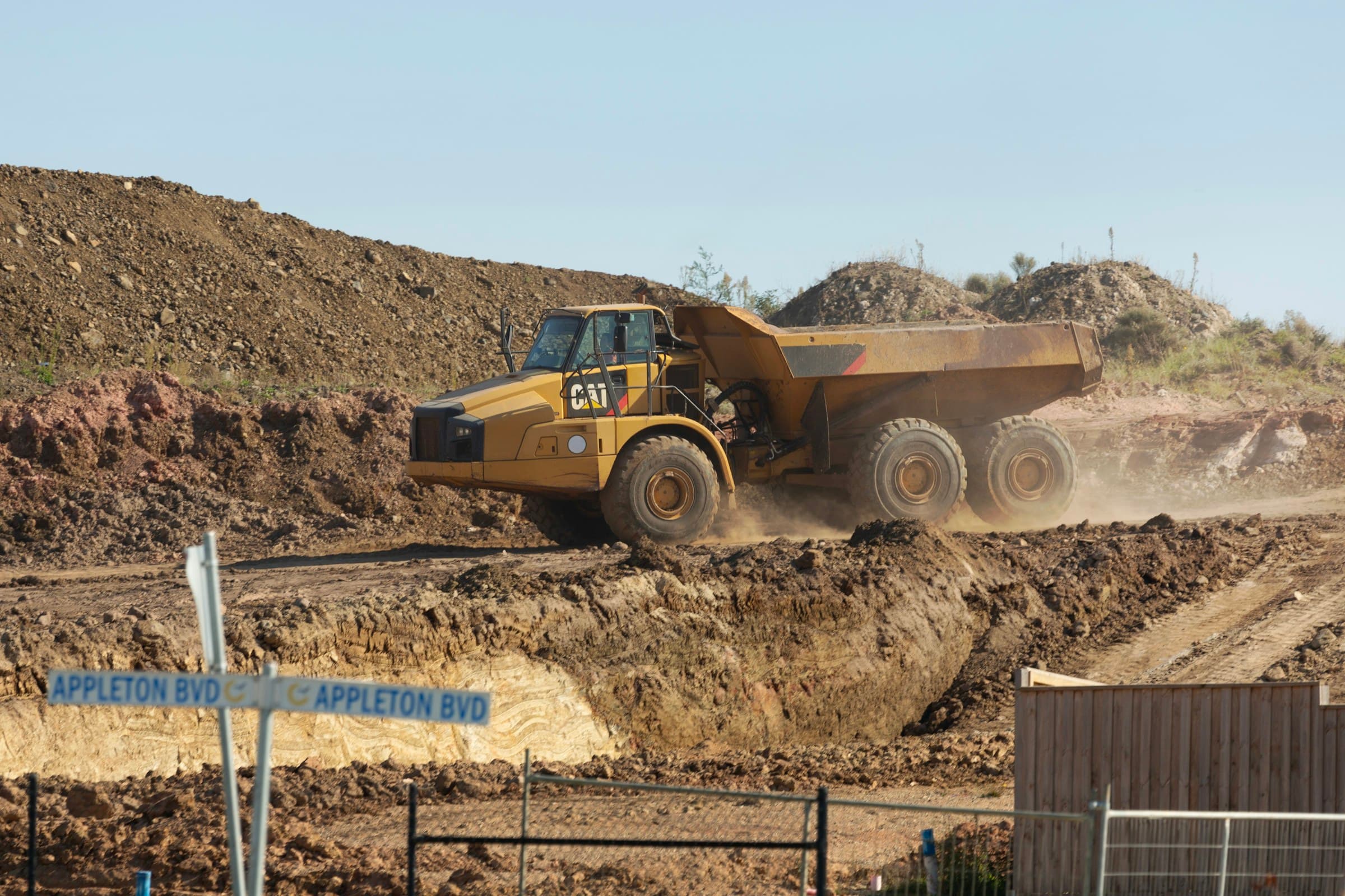 A loaded dump truck moving material on a construction site